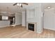 Open floor plan with wood floors and a fireplace that connects to the kitchen at 6512 Quarterbridge Ln, Charlotte, NC 28262