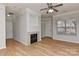Bright living room features wood floors, fireplace, and a large window at 6512 Quarterbridge Ln, Charlotte, NC 28262