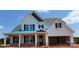 Charming two-story home with white siding, black shutters, and covered porch at 6707 Baker Creek Ave, Indian Land, SC 29707