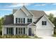 Charming two-story home with a covered porch, blue shutters, and a well-manicured lawn at 6707 Baker Creek Ave, Indian Land, SC 29707