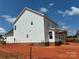 The side of this home features many windows and a covered patio at 6707 Baker Creek Ave, Indian Land, SC 29707