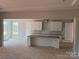 Bright kitchen features white cabinets, center island, and plenty of natural light at 6707 Baker Creek Ave, Indian Land, SC 29707