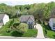 Aerial front view of home featuring driveway, lush landscaping, and well-maintained lawn at 7138 Dove Field Ln, Indian Land, SC 29707