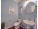Stylish powder room featuring a pedestal sink and nautical decor at 7138 Dove Field Ln, Indian Land, SC 29707