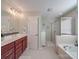 Bright bathroom features a soaking tub, walk-in shower, double vanity, and modern fixtures at 7138 Dove Field Ln, Indian Land, SC 29707