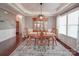 Elegant dining room featuring a classic wood table set, a china cabinet and an eye-catching light fixture at 7138 Dove Field Ln, Indian Land, SC 29707