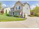 Beautiful home with an attached garage, long driveway, and lush, green lawn at 7138 Dove Field Ln, Indian Land, SC 29707