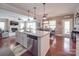 Open concept kitchen with granite countertops and stainless steel appliances overlooks a cozy living area at 7138 Dove Field Ln, Indian Land, SC 29707
