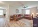 Cozy living room features hardwood floors, ceiling fan, and comfortable seating at 7138 Dove Field Ln, Indian Land, SC 29707