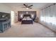 Spacious main bedroom features a stylish accent wall, ceiling fan, and ensuite bathroom at 7138 Dove Field Ln, Indian Land, SC 29707