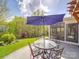 Outdoor patio area with dining table, umbrella, and view to large backyard at 7138 Dove Field Ln, Indian Land, SC 29707