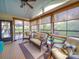 Bright sunroom with wicker seating, a ceiling fan, and panoramic views of the backyard at 7138 Dove Field Ln, Indian Land, SC 29707