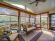 Relaxing sunroom filled with natural light, wicker furniture, and retractable window shades at 7138 Dove Field Ln, Indian Land, SC 29707