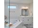 Elegant bathroom featuring a soaking tub, vanity with white cabinets, and neutral tiling at 8313 Balcony Bridge Rd, Huntersville, NC 28078