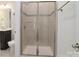 Modern bathroom features a glass-enclosed shower, gray-tile floors, and stylish fixtures at 8313 Balcony Bridge Rd, Huntersville, NC 28078