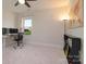Well-lit bedroom features neutral walls, a ceiling fan, and a desk near a window at 8313 Balcony Bridge Rd, Huntersville, NC 28078