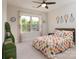 Bright bedroom with a ceiling fan, natural light from the window, and colorful decor that create a playful atmosphere at 8313 Balcony Bridge Rd, Huntersville, NC 28078