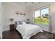 Comfortable bedroom featuring a large window providing natural light and a view of the outdoors at 8313 Balcony Bridge Rd, Huntersville, NC 28078