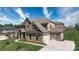 Beautiful brick home with a three-car garage and well-maintained landscaping at 8313 Balcony Bridge Rd, Huntersville, NC 28078