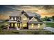 Stunning two-story brick home featuring manicured landscaping and a welcoming covered porch at 8313 Balcony Bridge Rd, Huntersville, NC 28078
