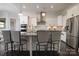 Modern kitchen with white cabinets, stainless steel appliances, granite countertops, and an island with barstool seating at 8313 Balcony Bridge Rd, Huntersville, NC 28078