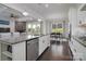 Open kitchen featuring granite countertops, stainless steel appliances, and seamlessly connected to the living and dining areas at 8313 Balcony Bridge Rd, Huntersville, NC 28078