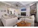 Cozy living room with coffered ceilings, stone fireplace, and modern decor elements at 8313 Balcony Bridge Rd, Huntersville, NC 28078