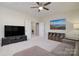 Spacious room with neutral colors, a ceiling fan, TV, sofa and decor that create a relaxing living area at 8313 Balcony Bridge Rd, Huntersville, NC 28078