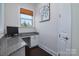 Compact office nook featuring granite counters, built-in storage, and a bright window at 8313 Balcony Bridge Rd, Huntersville, NC 28078