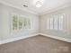 Empty bedroom with carpeted floors and two large windows with great natural light at 8623 Tullamore Park Cir, Charlotte, NC 28226