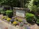 Community sign reads 'Challis Farm' surrounded by colorful flowers and greenery at 8623 Tullamore Park Cir, Charlotte, NC 28226