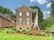 A charming brick home showcasing a symmetrical design, complemented by lush landscaping and mature trees at 8623 Tullamore Park Cir, Charlotte, NC 28226