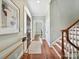 Welcoming foyer with hardwood floors, elegant staircase, and modern decor for a sophisticated entry at 8623 Tullamore Park Cir, Charlotte, NC 28226