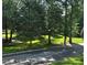 View of the green space on a tree lined street at 8623 Tullamore Park Cir, Charlotte, NC 28226