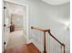 Bright hallway with hardwood floors, staircase, and view into bedroom with natural light at 8623 Tullamore Park Cir, Charlotte, NC 28226