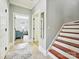 Inviting hallway with wood stairs and a view into a bright sitting room at 8623 Tullamore Park Cir, Charlotte, NC 28226