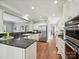 Bright kitchen with stainless steel appliances, granite countertops, and seamless flow to the living room at 8623 Tullamore Park Cir, Charlotte, NC 28226