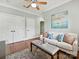 Cozy living room featuring hardwood floors, a white sofa, ceiling fan, and natural light at 8623 Tullamore Park Cir, Charlotte, NC 28226