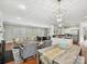 Open floor plan connecting the living room, dining area, and kitchen with modern lighting fixtures at 8623 Tullamore Park Cir, Charlotte, NC 28226