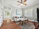 Bright living room with hardwood floors, a white sofa, ceiling fan, and natural light at 8623 Tullamore Park Cir, Charlotte, NC 28226