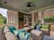 Inviting outdoor patio with comfortable seating, ceiling fan, and brick accents for relaxation and entertainment at 8623 Tullamore Park Cir, Charlotte, NC 28226