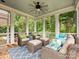 Relaxing screened-in porch with cozy seating arrangements and peaceful views of the surrounding greenery at 8623 Tullamore Park Cir, Charlotte, NC 28226