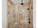 Walk-in shower boasts multiple shower heads and a built-in soap niche with neutral toned tile at 8623 Tullamore Park Cir, Charlotte, NC 28226
