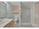 Clean bathroom includes tiled floor, built-in storage, toilet, and glass-enclosed shower at 8974, 8972 & 8970 Nc 90 E Hwy, Stony Point, NC 28678