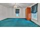 Spacious bedroom with teal carpet, two windows, wood storage cabinet, and crystal chandelier at 8974, 8972 & 8970 Nc 90 E Hwy, Stony Point, NC 28678