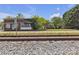 Exterior view of a brick building near a railroad track surrounded by trees and greenery at 8974, 8972 & 8970 Nc 90 E Hwy, Stony Point, NC 28678