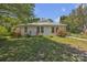 This home is surrounded by lush greenery, vibrant flowers, and a well-maintained lawn on a sunny day at 8974, 8972 & 8970 Nc 90 E Hwy, Stony Point, NC 28678