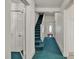 Hallway with green carpet, white walls, staircase and multiple doorways, providing a well-connected space at 8974, 8972 & 8970 Nc 90 E Hwy, Stony Point, NC 28678
