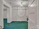 Hallway showcases teal carpet, multiple closets with white doors, and decorative lighting fixture at 8974, 8972 & 8970 Nc 90 E Hwy, Stony Point, NC 28678