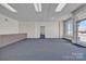Spacious interior space with carpeted flooring, neutral walls, and ample natural light at 8974, 8972 & 8970 Nc 90 E Hwy, Stony Point, NC 28678